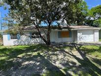 Charming single-story home with white painted brick and blue shutters at 4534 Lemans Dr, Orlando, FL 32808