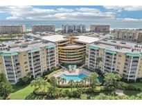 Expansive aerial view of a luxury condo complex with a central pool and ocean view at 4650 Links Village Dr # B103, Ponce Inlet, FL 32127