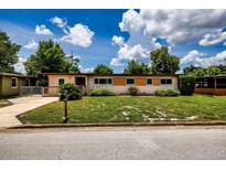 Charming single-story home with a well-maintained lawn and inviting curb appeal at 6310 Lake Underhill Rd, Orlando, FL 32807