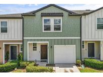 Inviting two-story townhome with a one-car garage and charming, well-maintained landscaping at 827 Grandin St, Davenport, FL 33837
