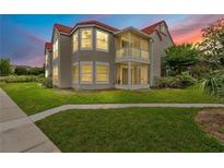 Charming condo featuring a red tile roof, well-maintained lawn, and a screened porch, perfect for relaxing outdoors at 900 Northern Dancer Way # 204, Casselberry, FL 32707