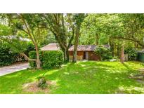 Charming single-story home nestled in lush greenery with a well-maintained lawn and cozy curb appeal at 109 Poinciana Ln, Deltona, FL 32738