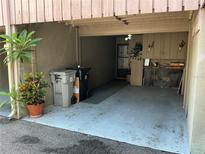 Attached carport featuring ample space for parking and extra storage with gray concrete flooring at 1409 Oak Pl # F, Apopka, FL 32712