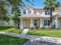 Charming two-story home with a well-manicured lawn and inviting front porch at 1521 Tranquil Ave, Clermont, FL 34714