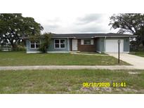 Charming single-story home with well-maintained lawn, attached garage, and inviting curb appeal at 1952 English Dr, Deltona, FL 32738