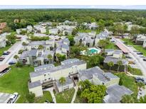 Scenic aerial view of community featuring mature trees and a refreshing neighborhood pool at 208 Scottsdale Sq # 208, Winter Park, FL 32792