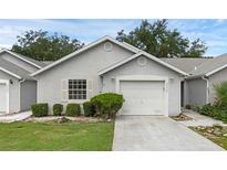 Charming single-story home featuring a well-maintained lawn, a two-car garage and a clean white exterior at 2404 Sw 20Th Ter, Ocala, FL 34471