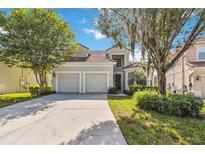 Charming two-story home featuring a two-car garage, well-maintained landscaping and a lovely tiled roof at 2616 Bowring St, Kissimmee, FL 34747