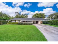Charming single-story home with a well-maintained lawn and covered carport in a desirable neighborhood at 2809 Sanbina St, Winter Park, FL 32789