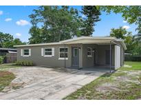 Charming single story home featuring neutral paint, white trim, and a covered carport at 709 Suzette Dr, Ocoee, FL 34761