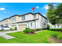 Beautiful two-story townhouse with a well-manicured lawn, neutral paint, and attached garage at 812 Benoi Dr, Davenport, FL 33896