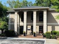 Attractive building with a covered entrance, columns, and well-manicured landscaping at 1055 Kensington Park Dr # 205, Altamonte Springs, FL 32714