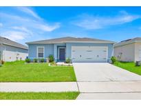 Charming single-story home with a well-maintained lawn and a two-car garage at 145 Piave St, Haines City, FL 33844