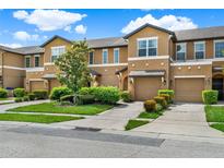 Attractive townhomes feature attached garages, neutral exteriors, landscaping and individual driveways at 2508 Seven Oaks Dr, St Cloud, FL 34772