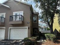Charming townhome featuring an attached garage, a private balcony, and mature landscaping at 2536 Lancien Ct # 5, Orlando, FL 32826
