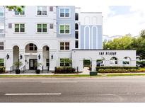 Beautiful exterior of The Grande, featuring manicured landscaping and covered entry at 300 E South St # 6016, Orlando, FL 32801