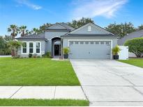 Charming single-story home with a well-manicured lawn, a two-car garage, and tasteful landscaping at 3101 Linton Rd, Kissimmee, FL 34758
