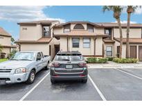 Exterior of two story condo with visible reserved parking spaces in front at 3118 S Semoran Blvd # 2, Orlando, FL 32822