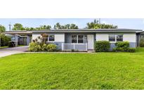 Charming single-story home featuring a well-manicured lawn, inviting entrance, and a convenient carport at 4006 Kasper Dr, Orlando, FL 32806