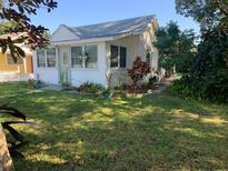 Charming single-story home with white siding and a well-manicured front lawn at 421 Ohio Ave, St Cloud, FL 34769