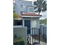Charming two-story townhome featuring a private front entrance with a well-maintained garden and walkway at 4741 Chevy Pl # 149C2L, Orlando, FL 32811