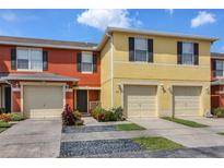 Inviting townhome featuring colorful exteriors, attached garages, and well maintained landscaping at 509 Cresting Oak Cir # 73, Orlando, FL 32824