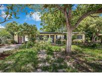Charming single-story home with mature trees and a well-maintained lawn at 905 Flewelling Ave, Ocoee, FL 34761