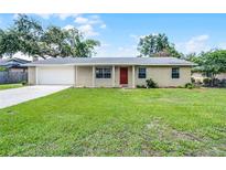 Charming single-story home features a well-maintained lawn, brick facade, and attached garage at 1011 W 13Th St, Lakeland, FL 33805