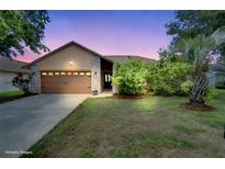 Charming single-Gathering home featuring a two-car garage and a beautifully landscaped front yard at 2406 Sweetwater Blvd, St Cloud, FL 34772