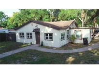 Charming single-story home with stucco exterior, brick walkway, and lush landscaping at 2515 Marlboro St, Orlando, FL 32806