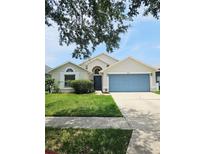Charming single-Gathering home features a well-maintained lawn, inviting entryway, and a convenient two-car garage at 2817 Moultrie Creek Dr, Kissimmee, FL 34743