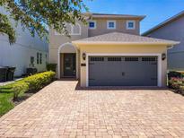 Charming two-story home featuring a paver driveway and a two-car garage at 370 Pendant Ct, Kissimmee, FL 34747