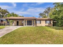 Charming single-story home with a spacious front yard and covered parking at 531 Wigman Dr, Eatonville, FL 32751