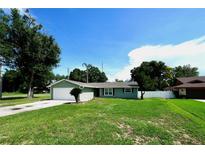 Charming single-story home features a well-maintained lawn and attached garage at 5472 E Grant St, Orlando, FL 32812