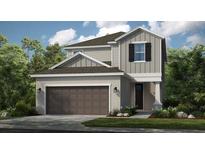 Charming two-story home with neutral siding, a two-car garage, and well-maintained landscaping at 5626 Portico Pl, Kissimmee, FL 34758