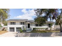 Beautiful two-story home with brick wall, mature landscaping and two car garage at 627 N Cherokee Ave, Deland, FL 32724