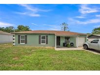 Charming one-story home with a well-maintained lawn and attached one-car garage at 6401 Fortune Ln, Apopka, FL 32712
