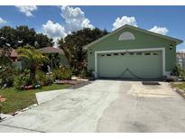 Charming single-Gathering home with a well-maintained lawn and driveway leading to an attached garage at 665 Regency Way, Kissimmee, FL 34758