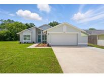 Charming single-story home featuring a well-manicured lawn, a two-car garage, and a welcoming blue front door at 841 Wesson Ct, Casselberry, FL 32707