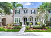 Charming two-story home with landscaped yard and covered front porch, perfect for enjoying the outdoors at 14460 Orchard Hills Blvd, Winter Garden, FL 34787