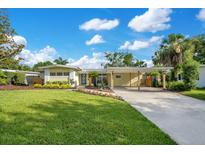 Charming single-story home with well-manicured lawn, covered carport, and inviting curb appeal at 1926 Natalen Rd, Winter Park, FL 32792