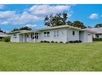 Lovely single-story home with a lush green lawn, offering a serene and inviting curb appeal at 216 N Riverside Dr, Edgewater, FL 32132