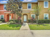 Charming multi-colored townhome featuring manicured landscaping and a welcoming entrance at 3010 Secret Lake Dr, Kissimmee, FL 34747