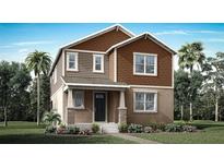 Charming two-story home with brown siding, landscaped yard, and a welcoming front porch at 504 Green Tracker Ave, Clermont, FL 34715
