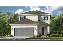 Inviting two-story home with a neutral color scheme, attached two-car garage, and well-maintained landscaping at 5709 Gingham Dr, Kissimmee, FL 34758
