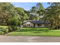 Charming home with stone accents, lush landscaping, and a well-manicured lawn at 643 Princewood Dr, Deland, FL 32724