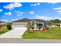 Charming single-story home featuring a two-car garage, well-maintained lawn and inviting curb appeal at 845 Valnera Ct, Kissimmee, FL 34758