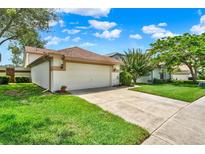 Charming single-story home featuring a well-manicured lawn and a two-car garage with a driveway at 11548 Pumpkin Seed Ct, Orlando, FL 32821