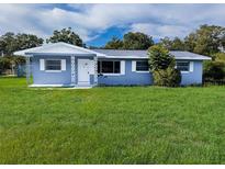 Charming one-story home with a freshly painted exterior, a well-manicured lawn, and decorative trim at 1200 Ne 45Th Pl, Ocala, FL 34479