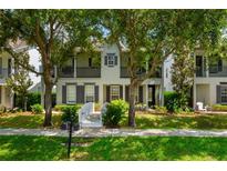 Charming two-story home with a walkway leading to the front door and mature trees in the front yard at 1615 Wilson Ave, Orlando, FL 32804